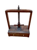 Regency mahogany table top book press with drawer on bun feet