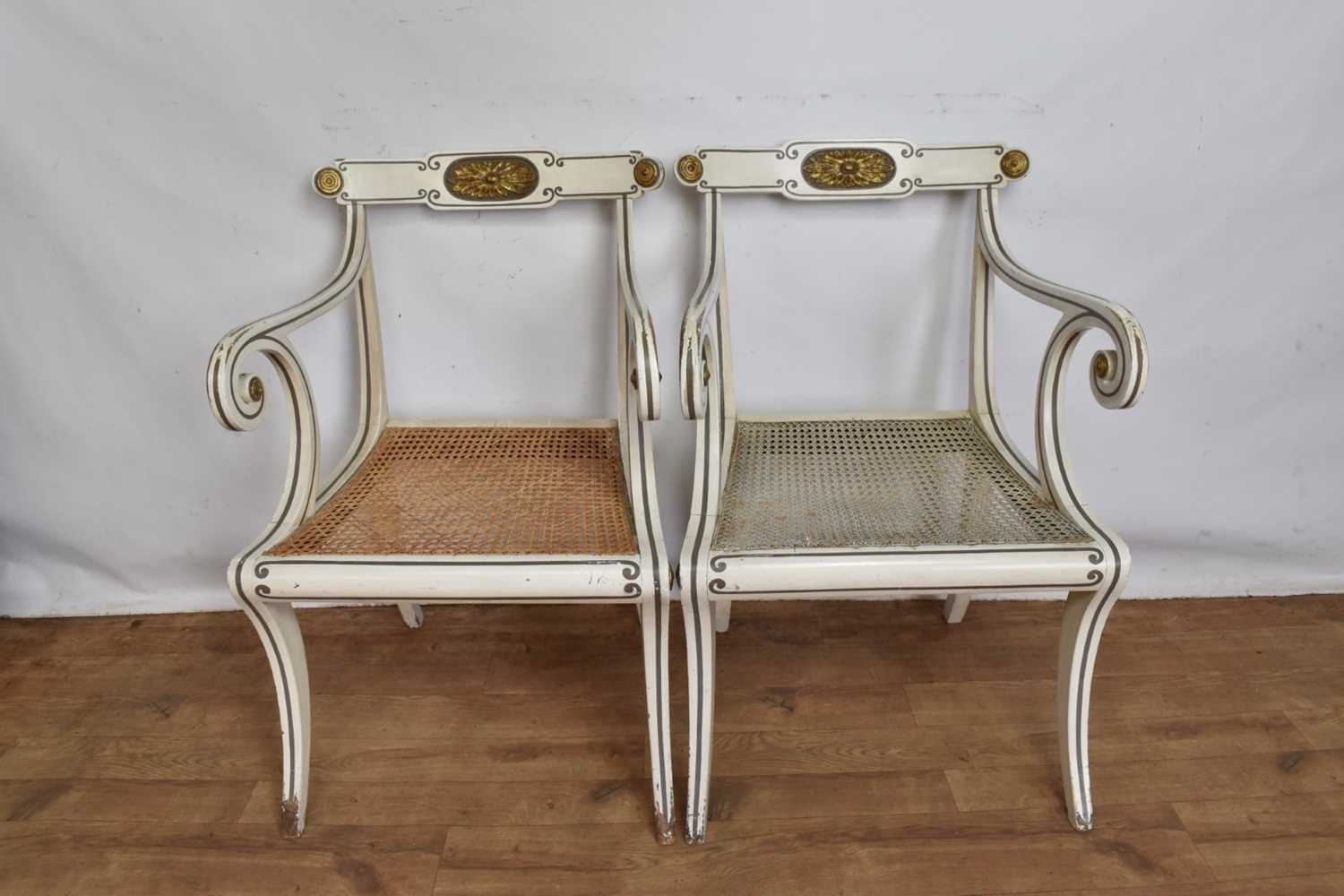 Pair of Regency style white painted and parcel gilt open elbow chairs with cane seats on sabre legs - Image 2 of 9