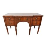 William IV mahogany breakfront sideboard with an arrangement of drawers, on turned and fluted legs