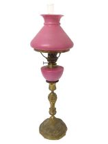 19th century peg lamp with pink glass shade and reservoir on ormolu candlestick base