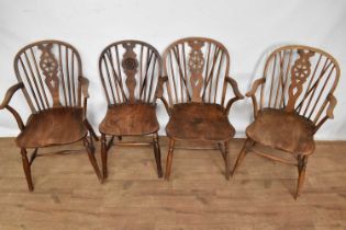 Three similar 19th century ash and elm wheel back Windsor elbow chairs and a similar side chair, eac