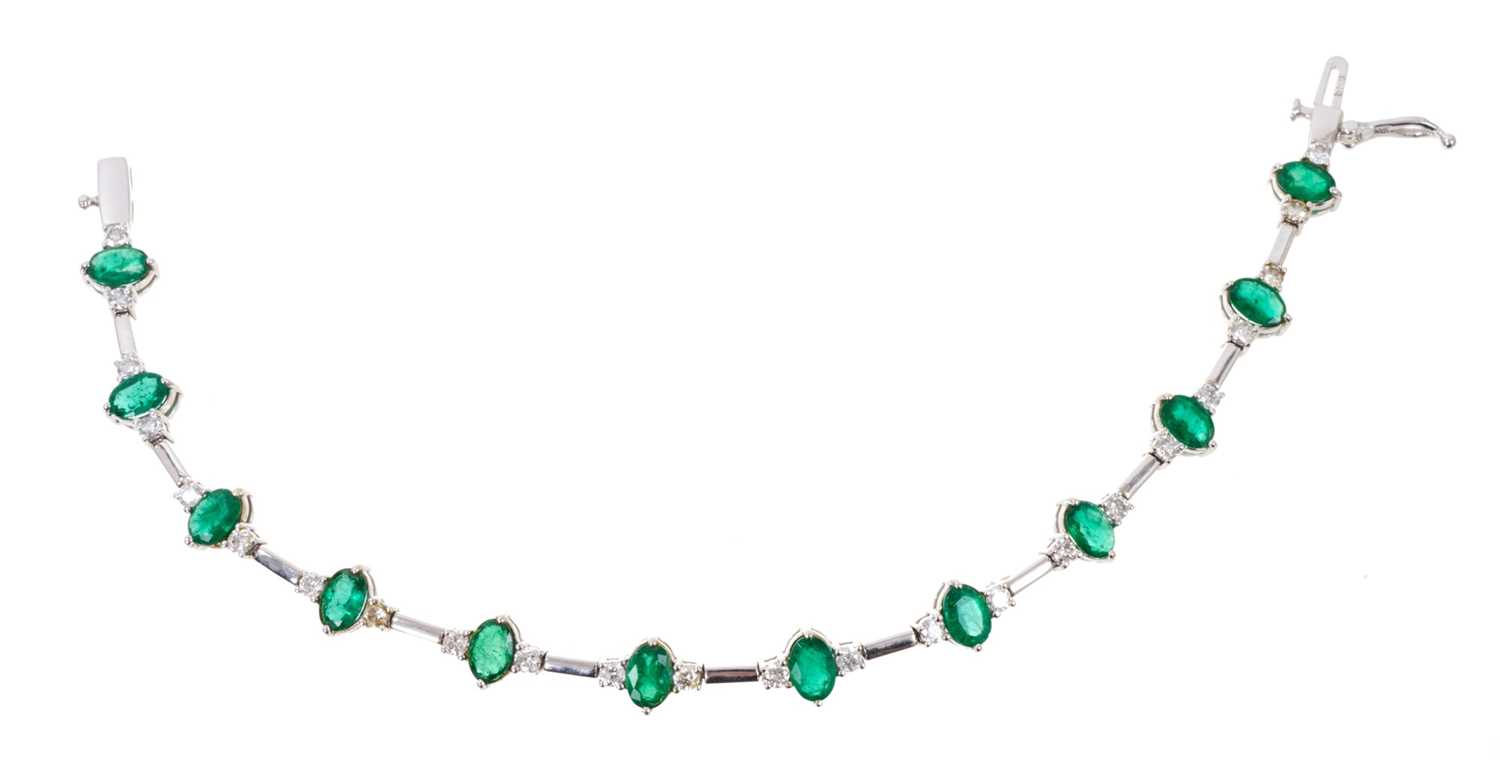 Emerald and diamond bracelet with a line of twelve oval mixed cut emeralds, each flanked by two bril - Image 3 of 3