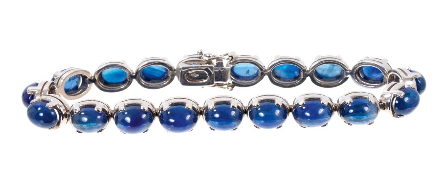 Cabochon blue sapphire and 18ct white gold bracelet with nineteen blue sapphire oval cabochons in 18