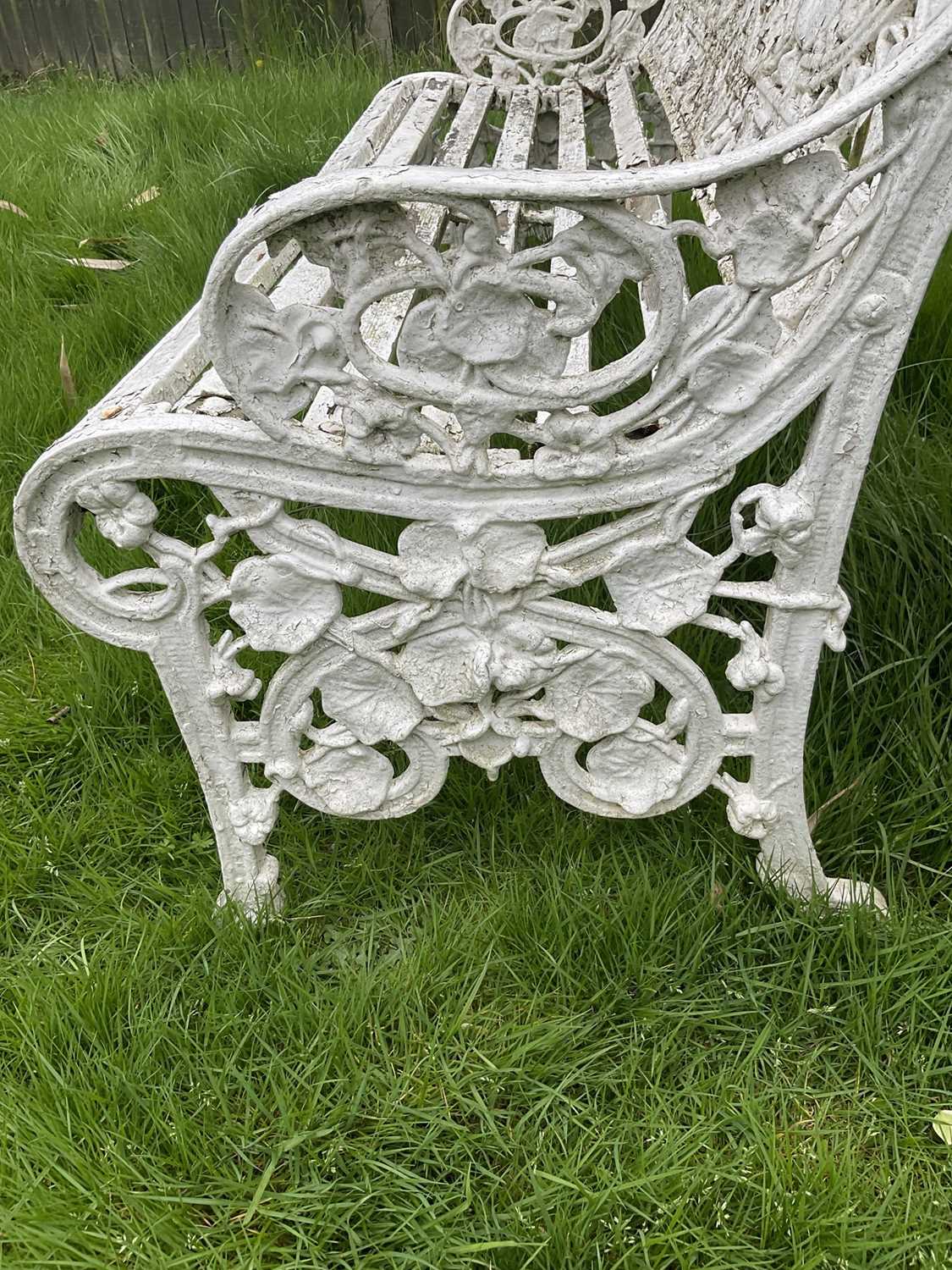 Victorian style white painted cast metal garden bench with lily pad and foliate design, 131cm wide. - Image 3 of 6