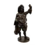 19th century bronze figure of a game dealer, on circular base, 29cm high