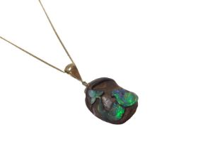 Carved black opal pendant on chain