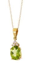 Peridot and diamond pendant necklace with an oval mixed cut peridot measuring approximately 8.2 x 6.