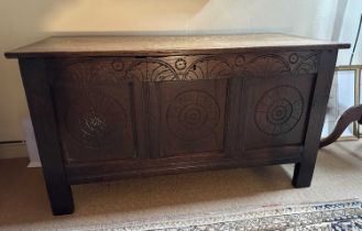 Antique oak coffer, earlier elements, with carved three panelled front, on black feet, 113cm wide x