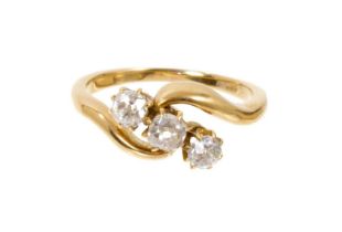 Diamond three stone ring in 18ct gold cross-over setting