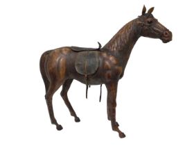 Large leather covered wooden horse in the style of Liberty