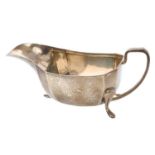 Late 1940s silver sauce boat of faceted form, with angular loop handle