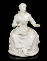 White glazed porcelain figure of a lacemaker