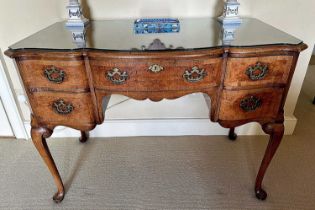 Queen Anne-style walnut dressing table by Waring & Gillows, with shaped serpentine top above an arra