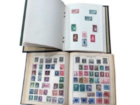 Two stamp albums and a collection of GB presentation packs