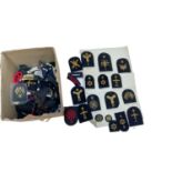 Collection of various British military cloth badges to include rank insignia and Royal Navy cap tall