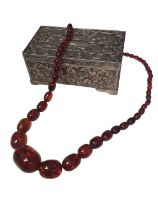 Vintage amber bead necklace with graduated oval polished beads, within a silver plated jewellery box