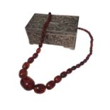 Vintage amber bead necklace with graduated oval polished beads, within a silver plated jewellery box