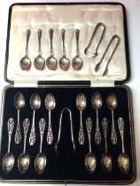 Cased set of twelve silver plated teaspoons and pair of sugar tongs all with pierced thistle decorat