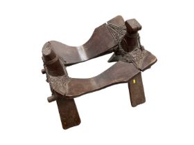 Early saddle possibly Tibetan or Chinese, together with a pair of stirrups