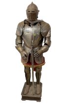 Reproduction steel suit of armour complete with helm and sword on wooden display stand