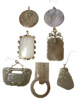 Seven Chinese jade/ hard stone carved pendants and panels, some in 14ct gold and yellow metal mounts