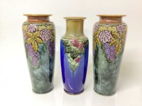 Pair of Royal Doulton vases with fruit and leaf decoration and another similar (3)