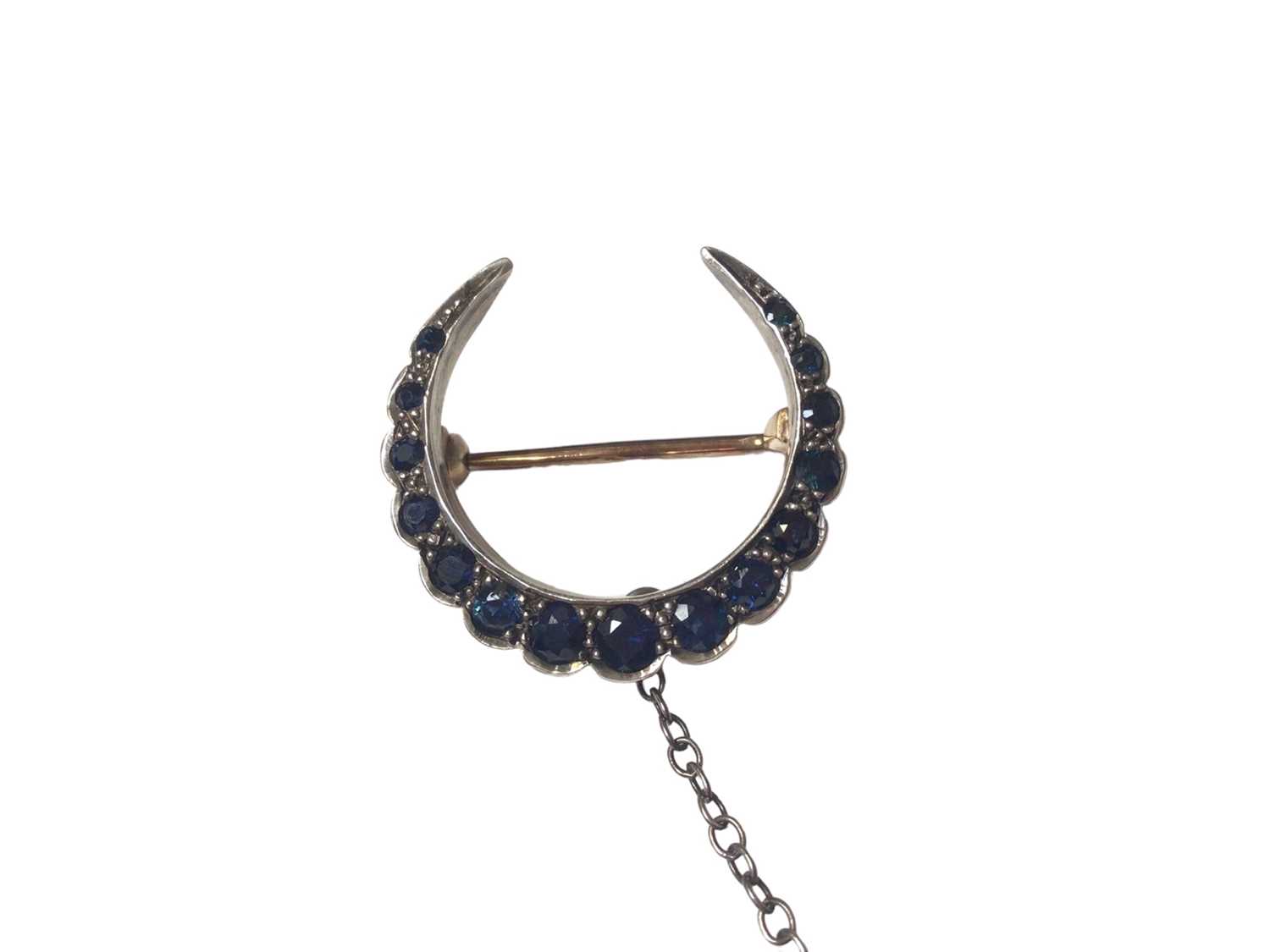 Victorian sapphire crescent brooch with fifteen graduated round mixed cut blue sapphires in a yellow