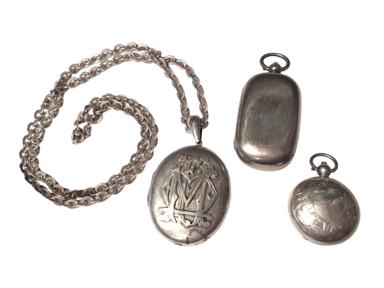 Victorian white metal oval locket with applied monogram on a later silver chain, together with two a
