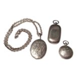 Victorian white metal oval locket with applied monogram on a later silver chain, together with two a