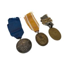 Nazi Police Long Service Award, Nazi German Defences Medal and another German medal (3).