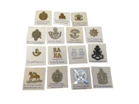 Collection of British military cap badges with annotations (1 box).