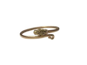 18ct gold torque bangle with leopard head terminal, black enamel spot decoration, a pair of ruby eye