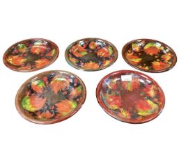 Set of five Moorcroft plates decorated with the Flambe Leaves pattern