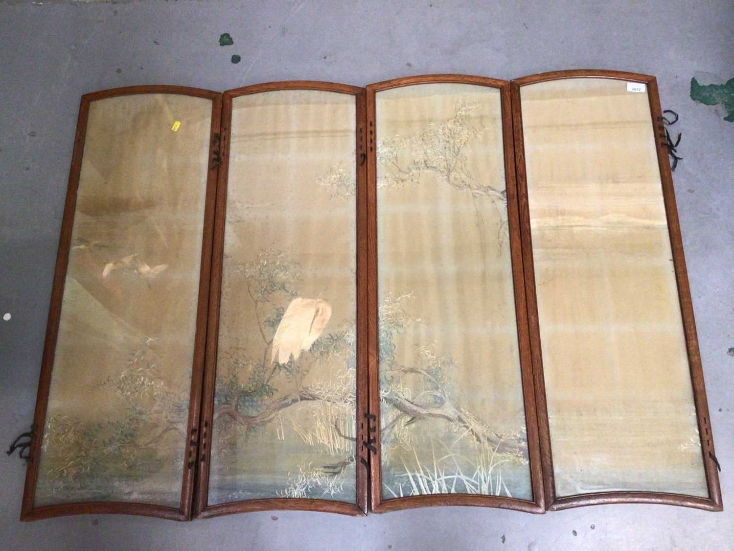 Four Japanese embroidered silk panels in oak interlacing frames making up a small folding screen, mu