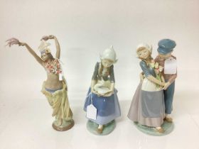 Three Lladro porcelain figures - semi clad dancer, 29cm high, Dutch couple and Dutch girl with goose