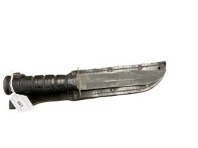 American military fighting knife with Bowie blade in leather sheath.