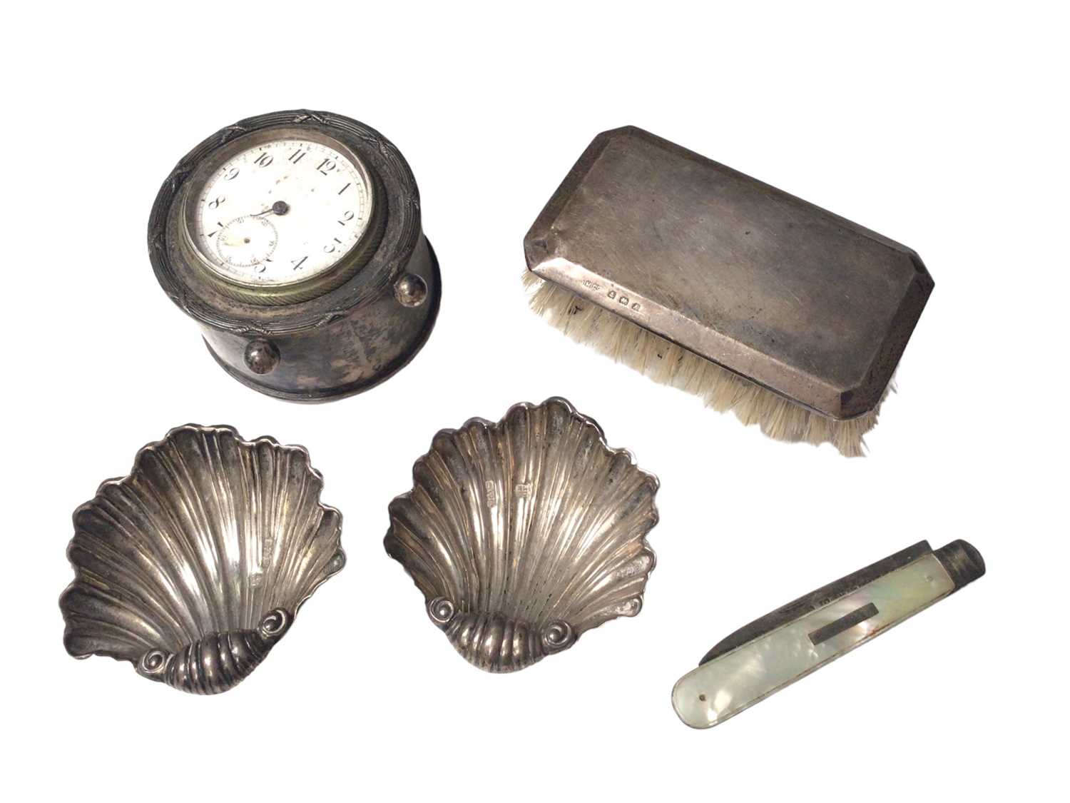 Pair of Edwardian silver shell salts, silver cased desk clock, silver backed brush and a silver and