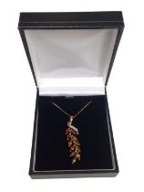 Citrine and diamond pendant, the stylised floral spray with marquise cut citrines and single cut dia