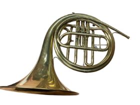 Brass French horn in case