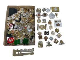 Collection of British military cap badges, (mainly staybrite), together with side cap and brass butt
