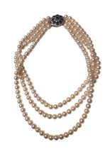 Cultured pearl three strand necklace on a 9ct white gold diamond and sapphire cluster clasp