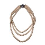 Cultured pearl three strand necklace on a 9ct white gold diamond and sapphire cluster clasp