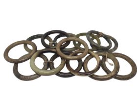 Fourteen green/ brown hard stone polished bangles, all approximately 8cm diameter