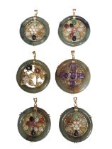 Six Chinese jade/ green hard stone circular gem set pendants with 14ct gold mounts