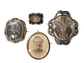 Four Georgian and later mourning and portrait miniature brooches including two with hairwork designs