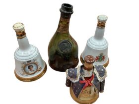 Three commemorative Bell's whisky decanters (full) and an old Armagnac bottle