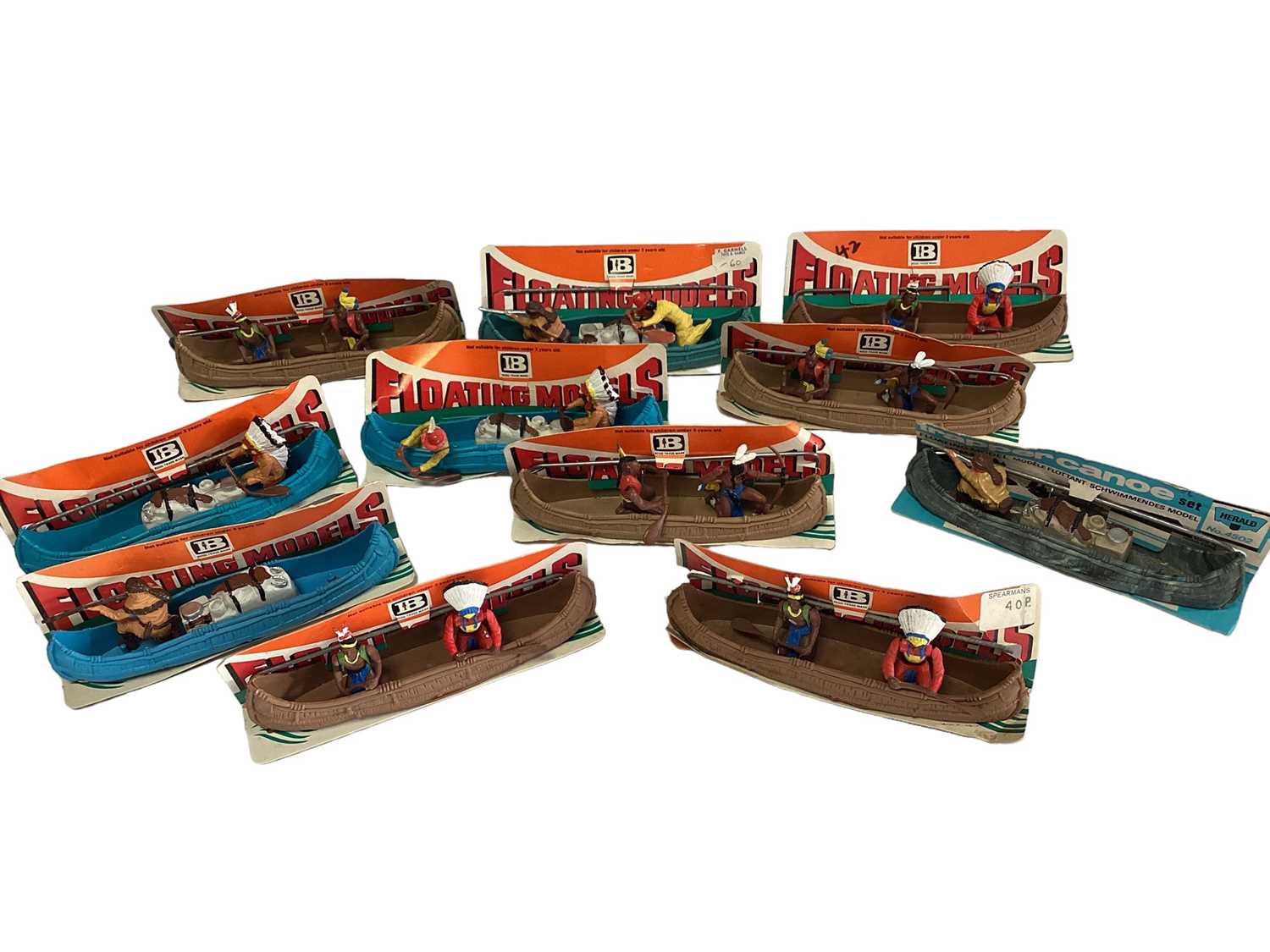 Britains floating models Canoes (some with figures missing), on card stand (11)