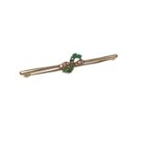 Emerald and diamond brooch with a cross-over design in 9ct gold setting