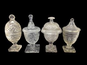 Group of four 19th century cut glass sweetmeat urns and covers, of varying shapes and sizes, 26cm to