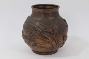 Japanese bronze footed vase, decorated with birds and bamboo in relief, character marks to base, 18c